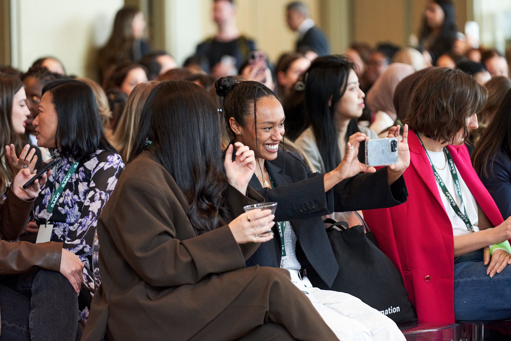  Monday Girl Summit attendees taking a fun selfie together in the audience 